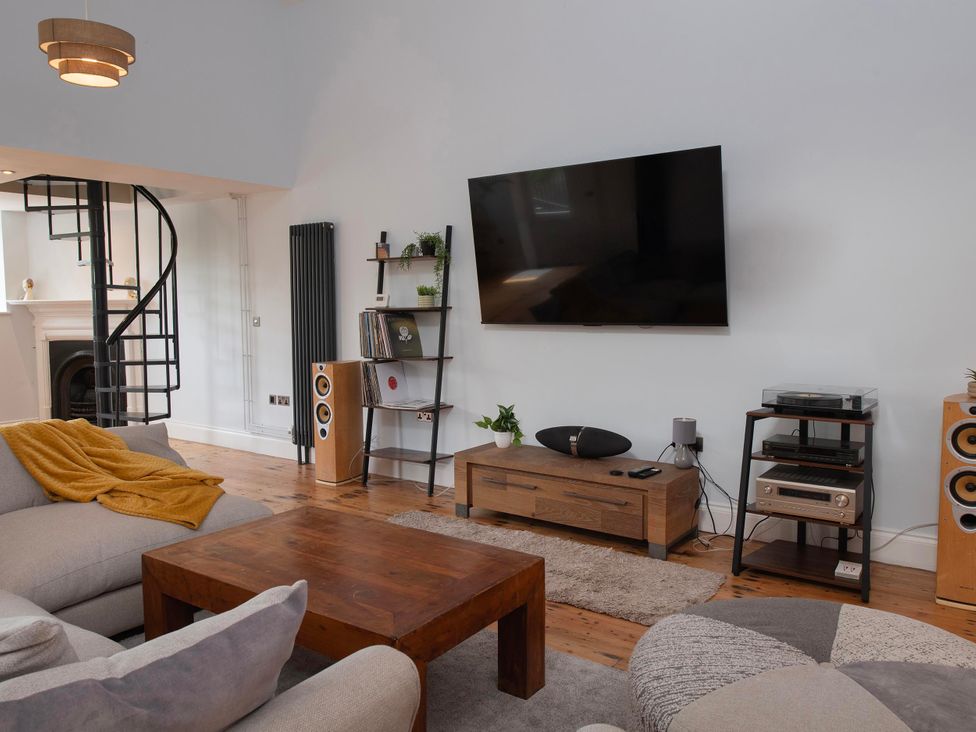 A living room with a television and seating arrangement at The Old School House 