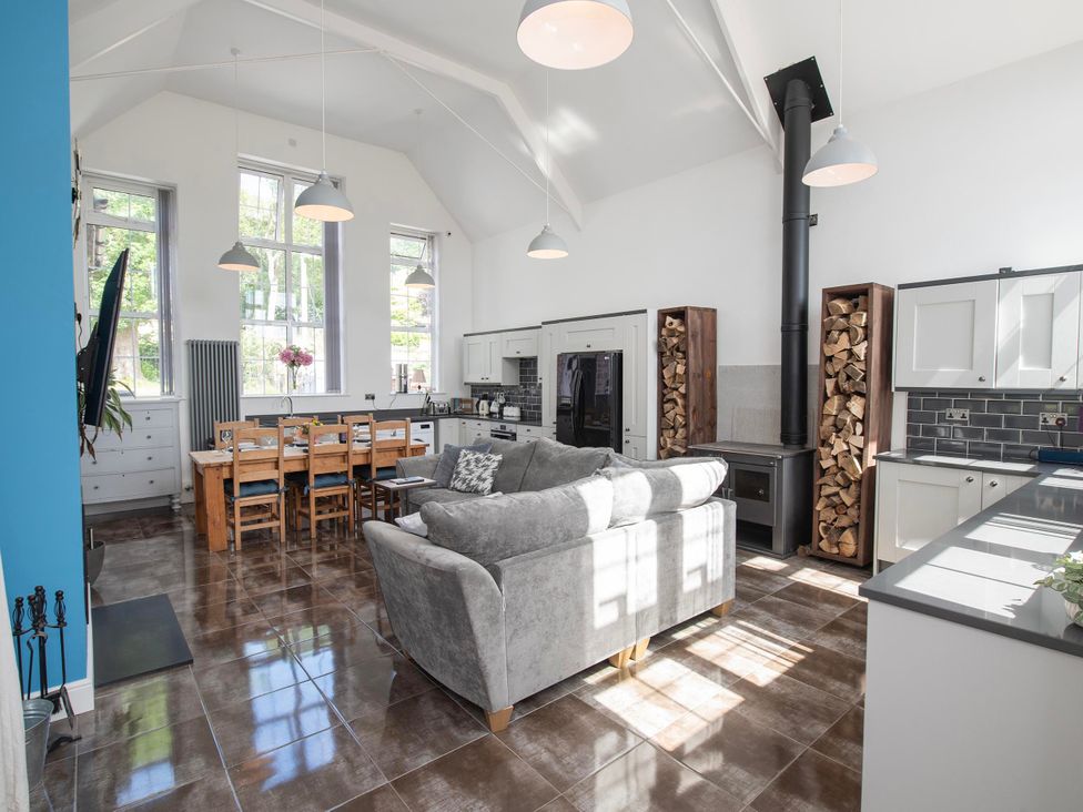 A living room with a dining table and chairs at The Old School House in 