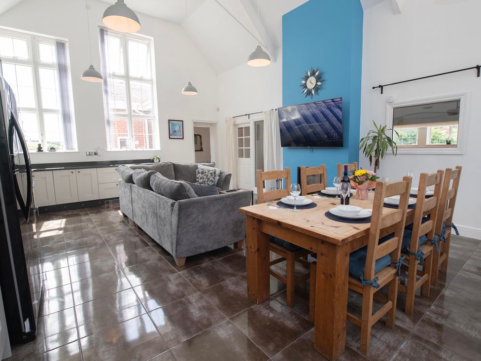 A living room with a sofa and dining area at The Old School House 