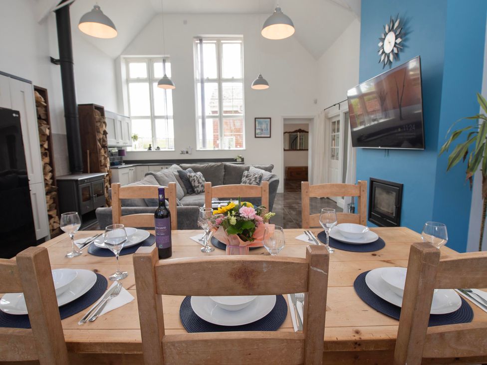 A dining area with a table set for meals at The Old School House in 