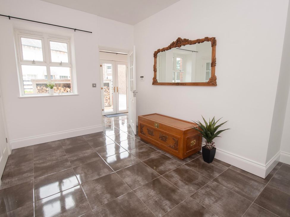 A hallway with a mirror and wooden chest at The Old School House