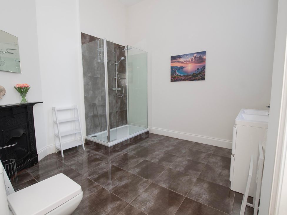 A bathroom with a shower, toilet, and sink at The Old School House 