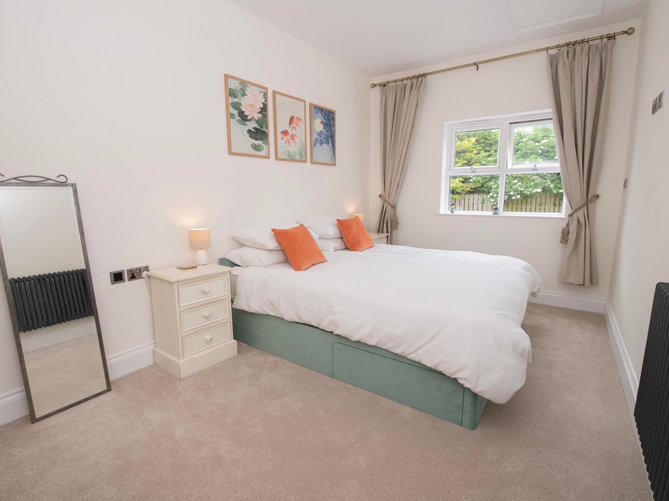 A bedroom with a bed and window at The Old School House