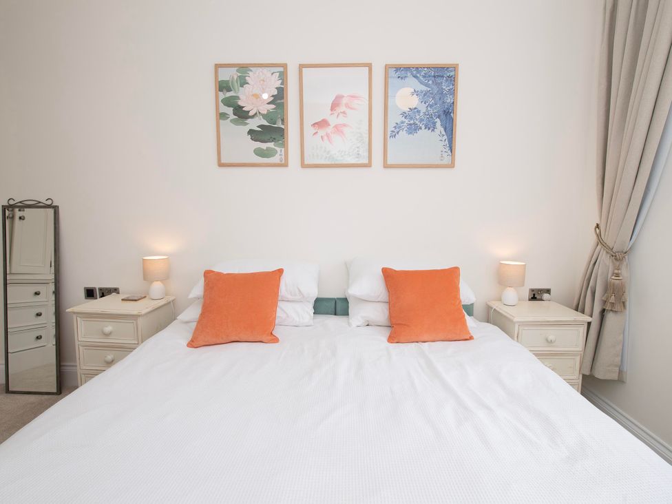 A bedroom with a bed and artworks on the wall at The Old School House