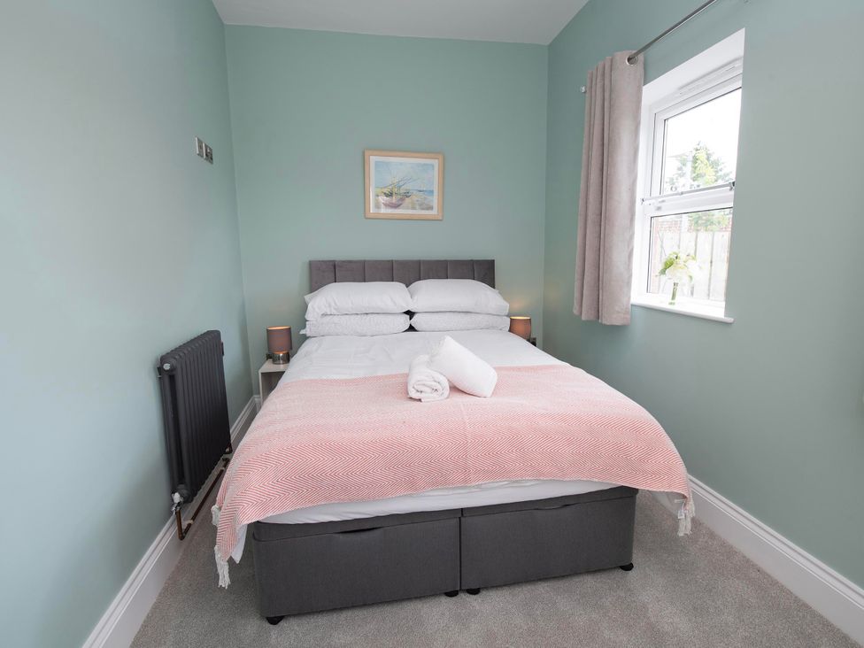 A bedroom with a bed and window at The Old School House 