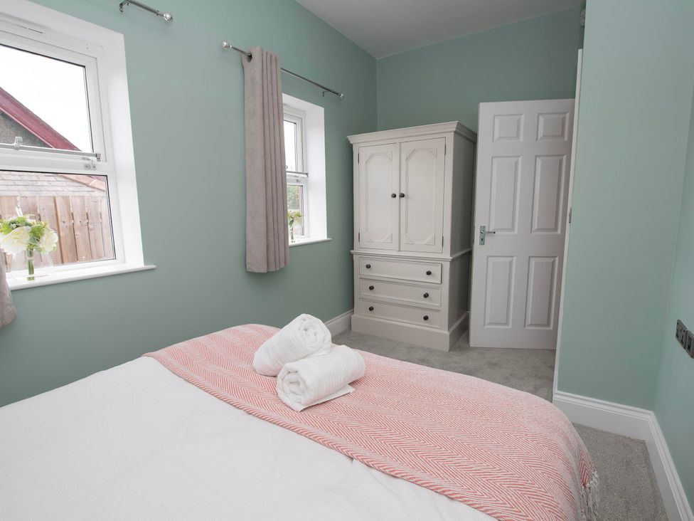A bedroom with a bed and wardrobe at The Old School House