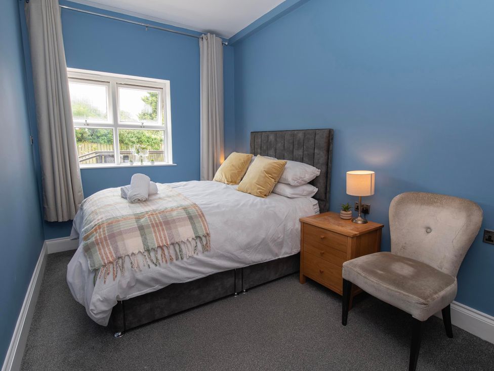 A bedroom with a bed and nightstand at The Old School House 
