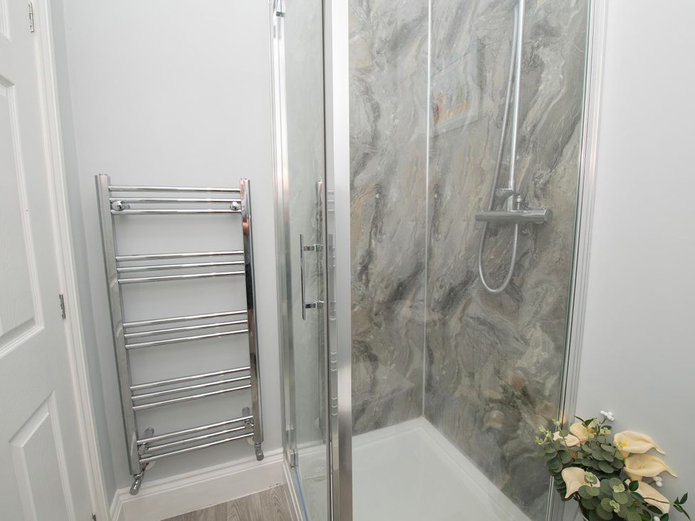 A bathroom with a shower and towel radiator at The Old School House