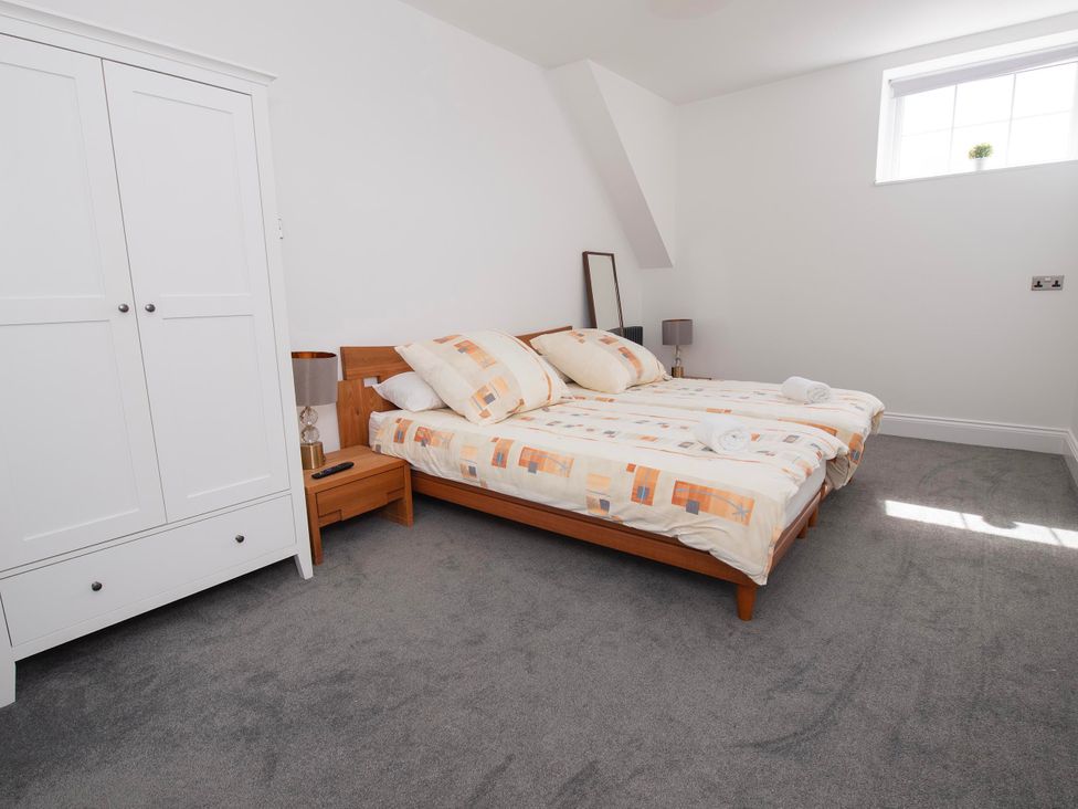 A bedroom with two beds and a wardrobe at The Old School House 