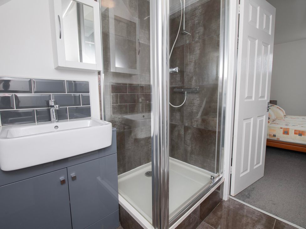 A bathroom with a shower and sink at The Old School House