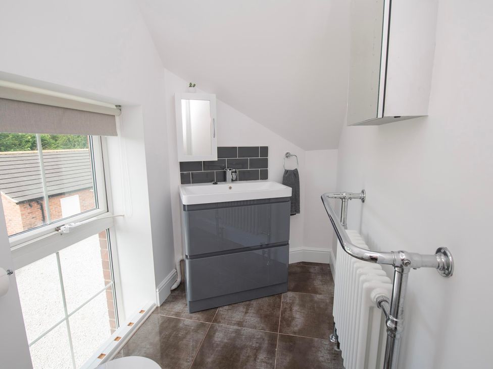 A bathroom with a sink and vanity unit at The Old School House in 