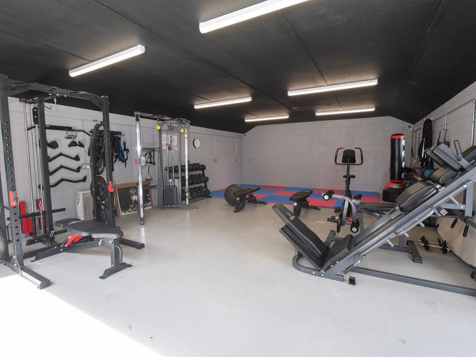 A gym with various exercise equipment at The Old School House in 