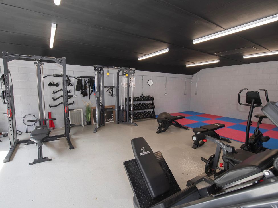 A gym with various fitness equipment at The Old School House
