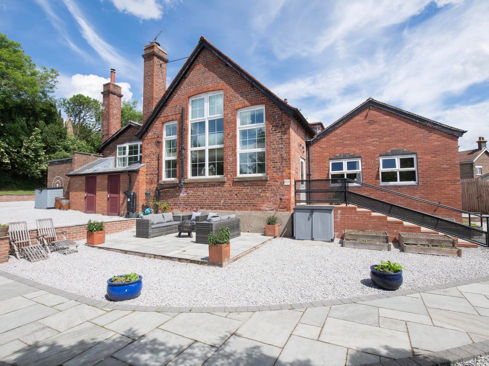An outdoor area with a seating arrangement and planters at The Old School House 