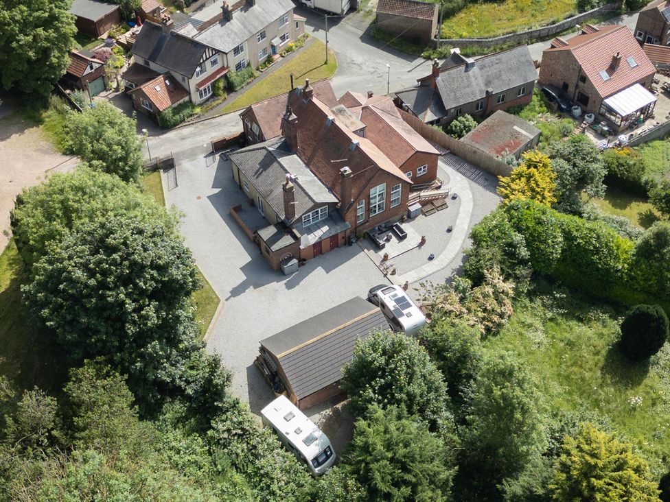 An aerial view of a property with cars and greenery at The Old School House 