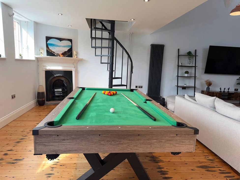 A game room with a pool table and staircase at The Old School House in Langtoft