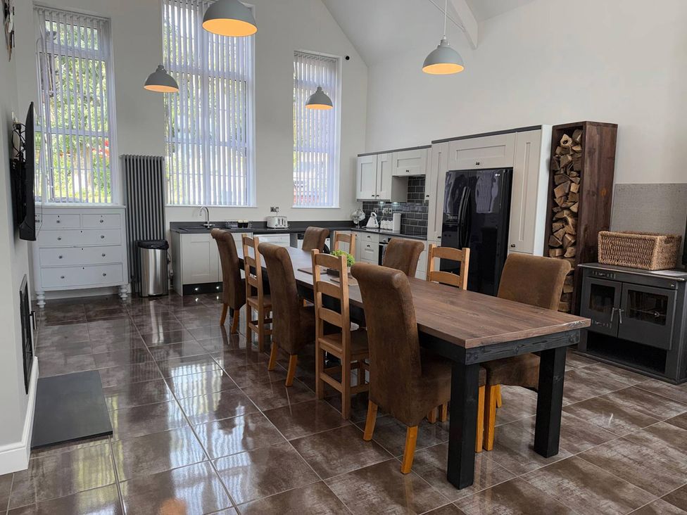A kitchen with dining table and chairs at The Old School House in Langtoft