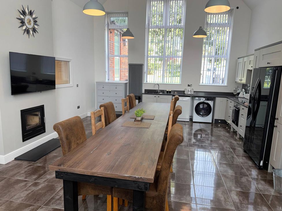 A kitchen with a dining table and chairs at The Old School House in Langtoft