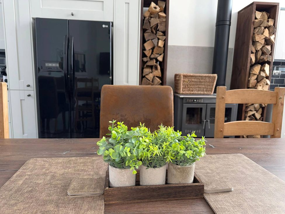 A kitchen with a table and potted plants at The Old School House in Langtoft