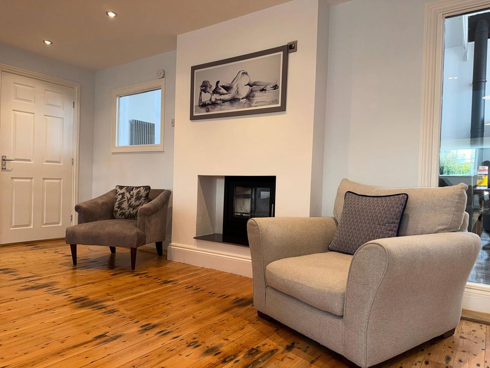 A living room with chairs and a fireplace at The Old School House in Langtoft