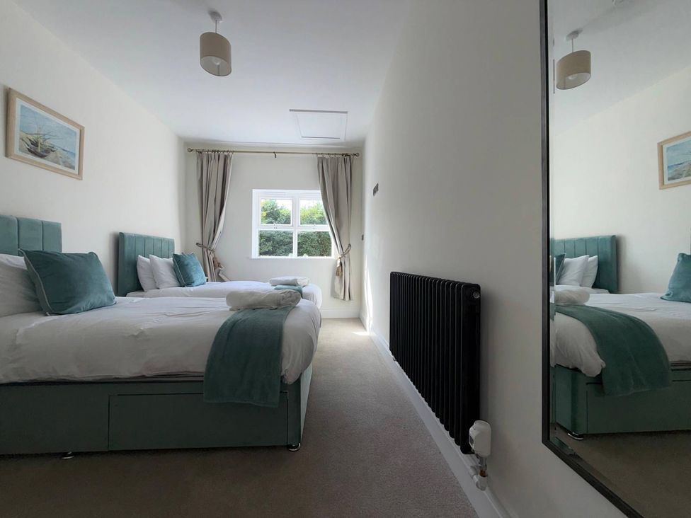A bedroom with two beds and a window at The Old School House Langtoft