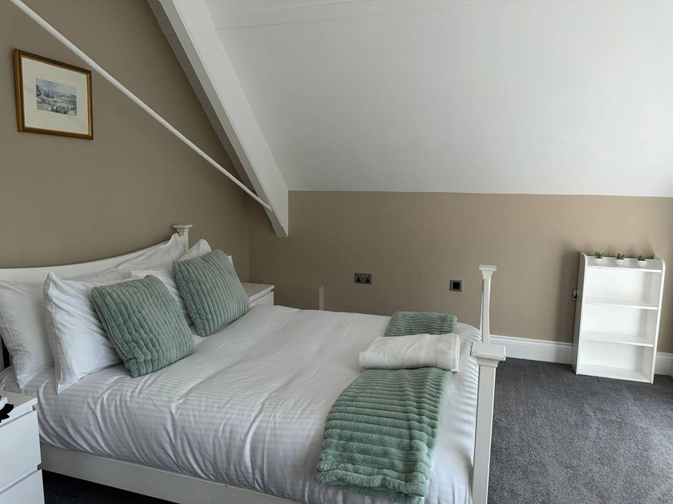 A bedroom with a bed and shelf at The Old School House in Langtoft