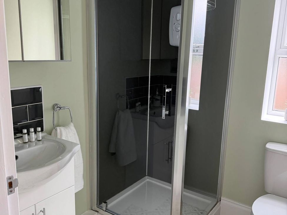 A bathroom with a shower and sink at The Old School House in Langtoft
