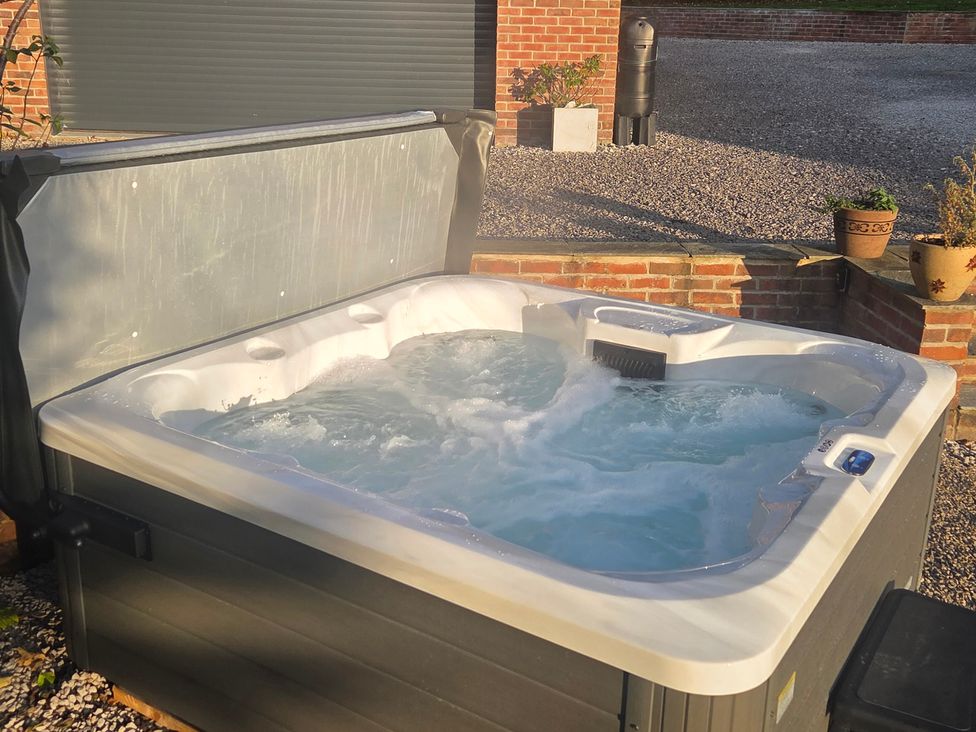 A hot tub with water outdoors at The Old School House in Langtoft