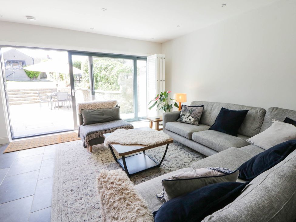 A living room with a sofa and coffee table at Rheidiol in St Davids