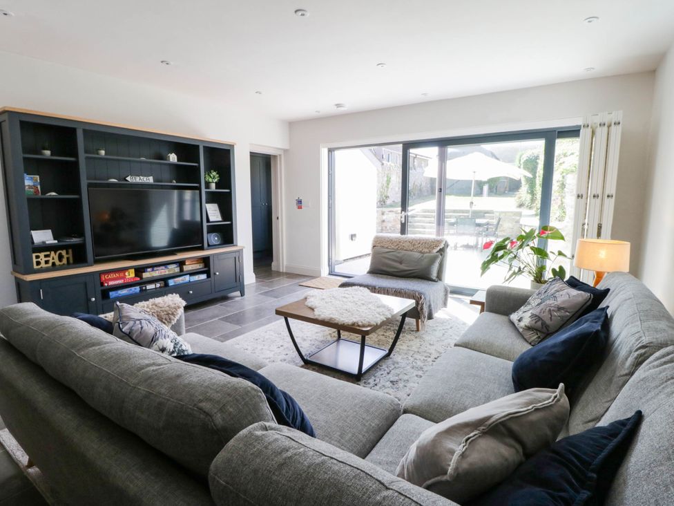 A living room with a television and sofa at Rheidiol in St Davids