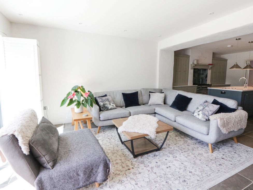 A living room with a sofa and armchair at Rheidiol in St Davids