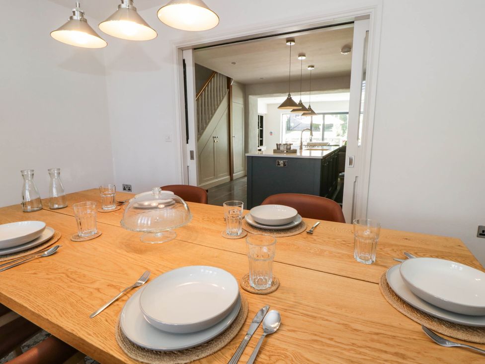 A dining room with a table set for meals at Rheidiol in St Davids