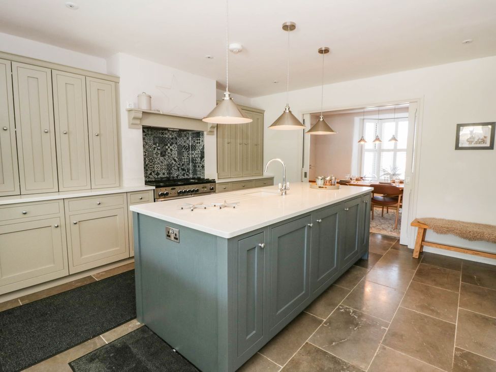 A kitchen with cabinets and an island at Rheidiol in St Davids