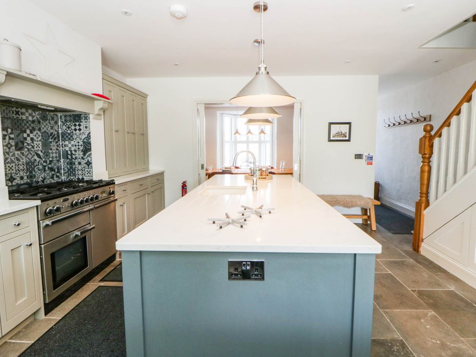 A kitchen with an island and stove at Rheidiol in St Davids