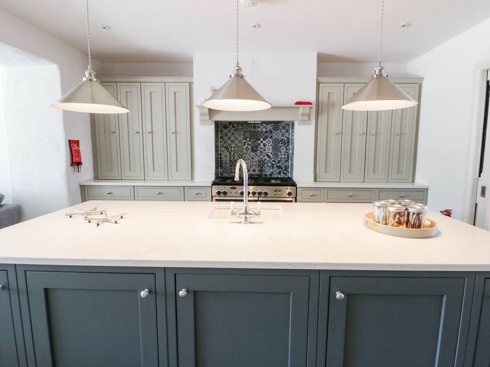 A kitchen with a central island and cooking range at Rheidiol in St Davids