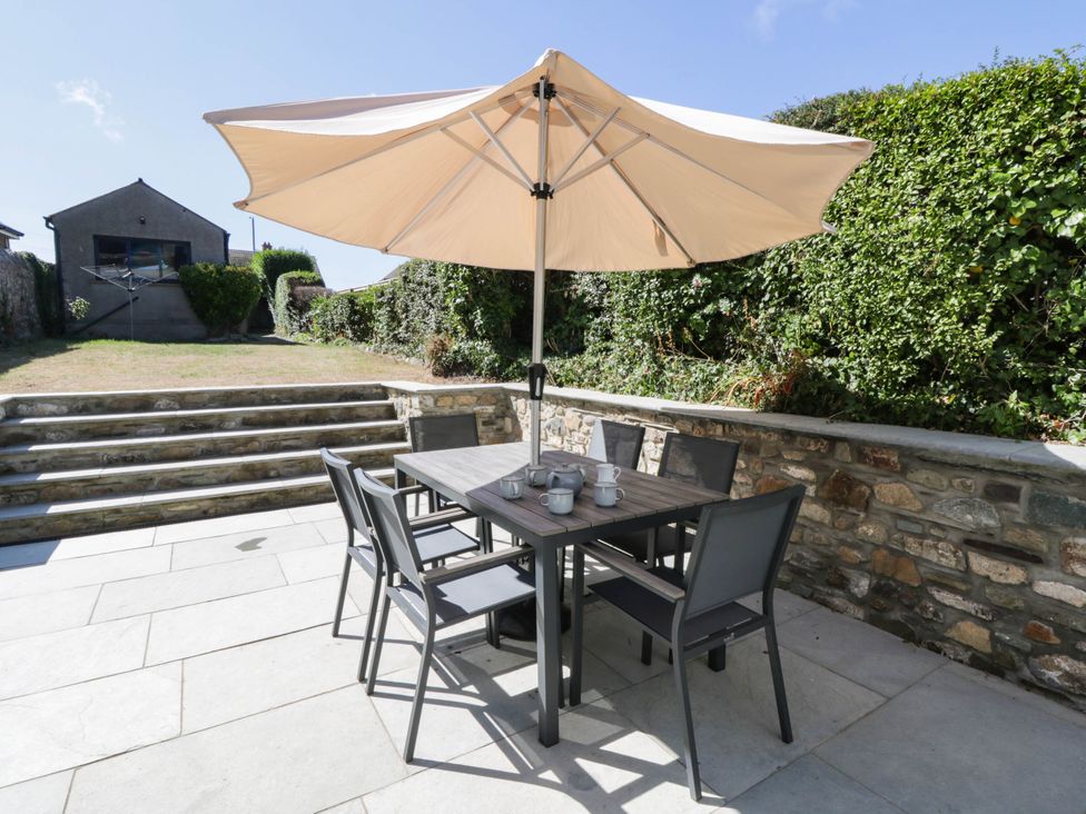 An outdoor dining area with a table and chairs at Rheidiol in St Davids