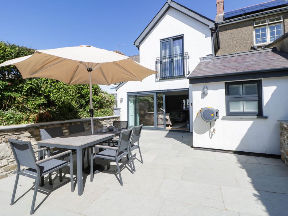 An outdoor dining area with a table and chairs at Rheidiol in St Davids