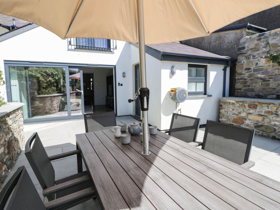 An outdoor dining area with a table and chairs at Rheidiol in St Davids