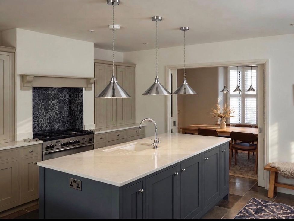 A kitchen with an island and a stove at Rheidiol in St Davids