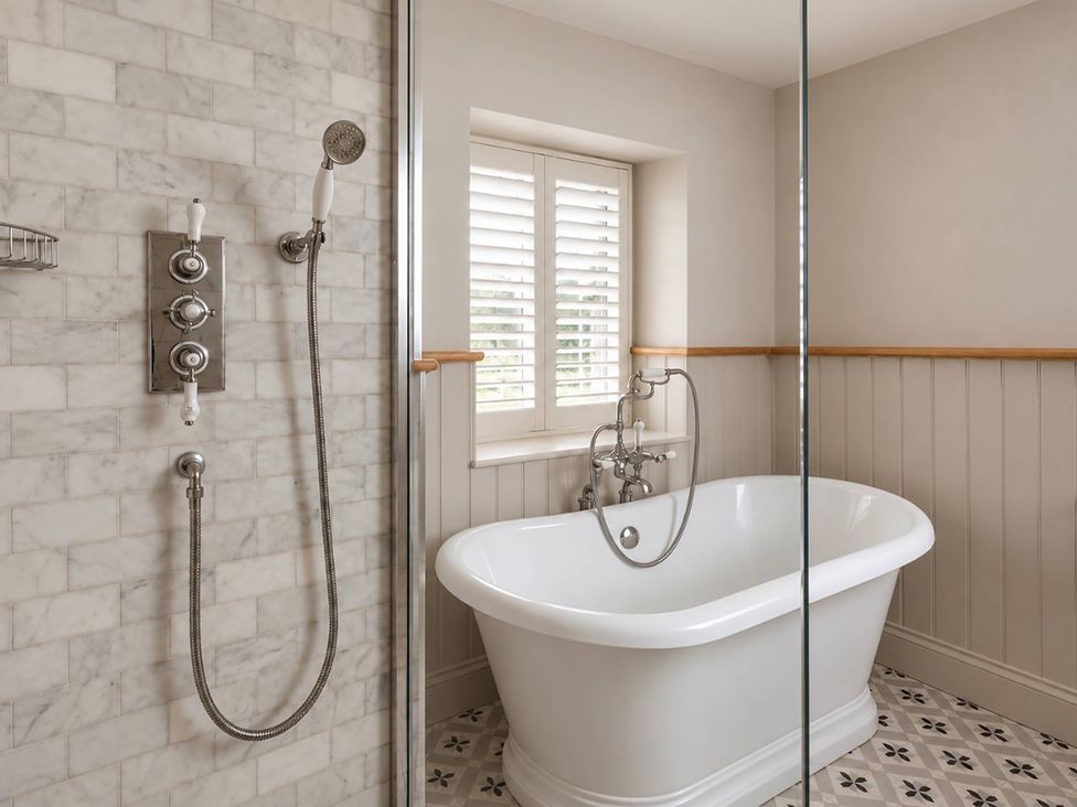 A bathroom with a bathtub and shower at Rheidiol in St Davids