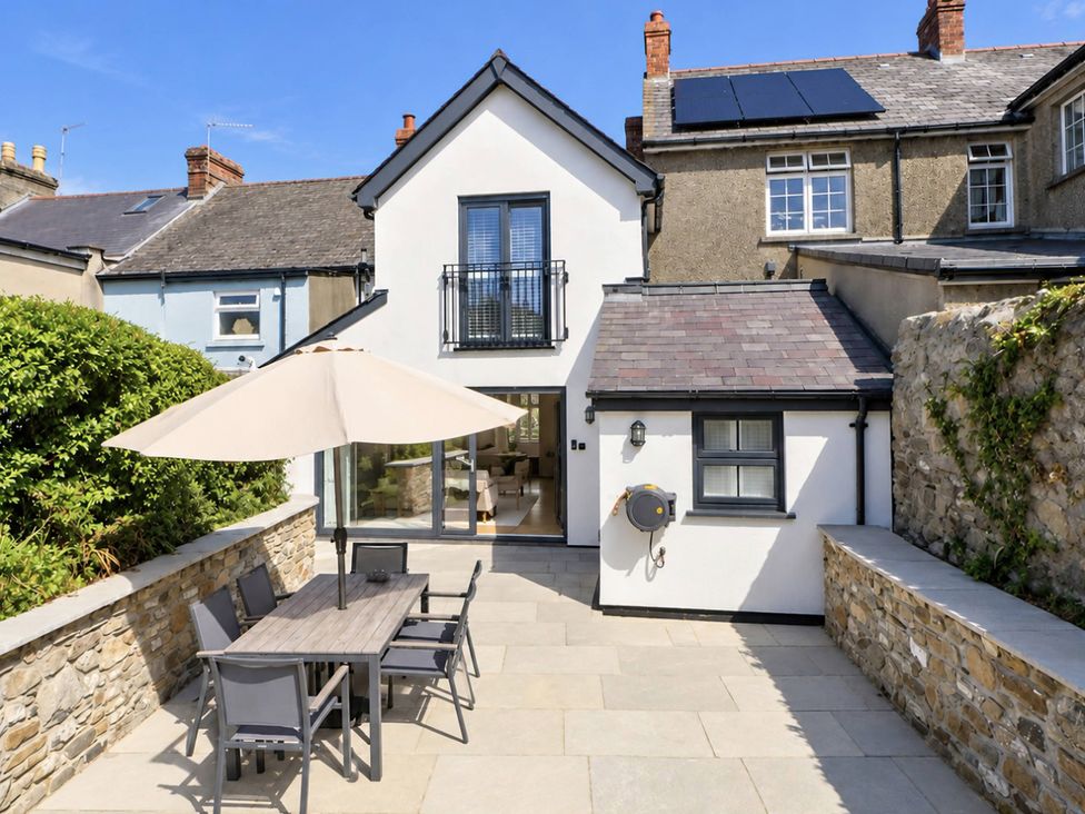 An outdoor dining area with a table and chairs at Rheidiol in St Davids
