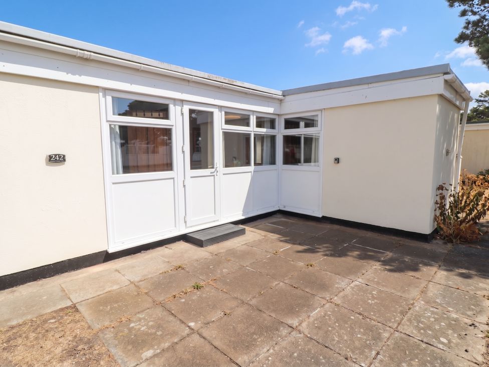 An outdoor area with doors and patio at Chalet 242 Carmarthen Bay in Kidwelly