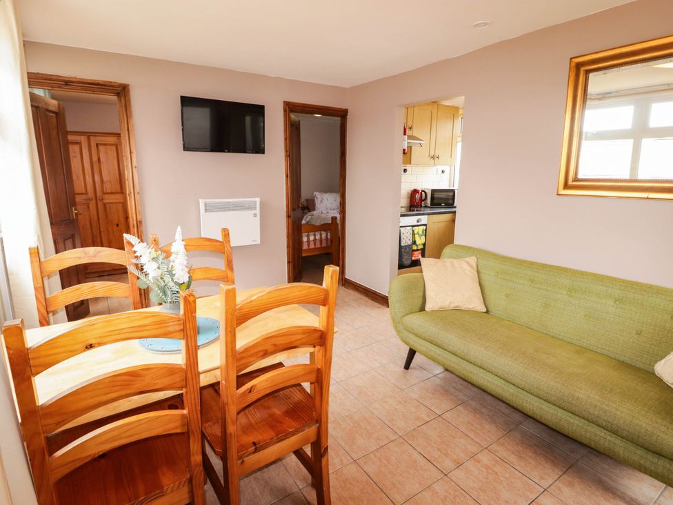 A dining area with table and chairs at Chalet 242 Carmarthen Bay Kidwelly