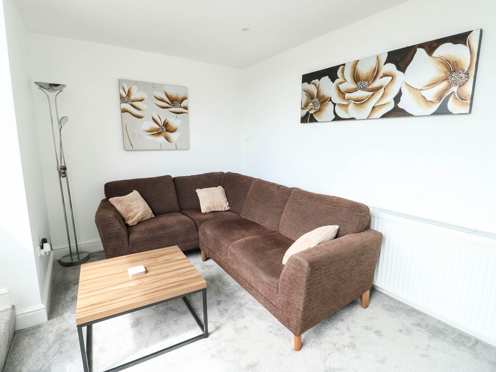 A living room with a sofa and a coffee table at River View in Betws-y-Coed