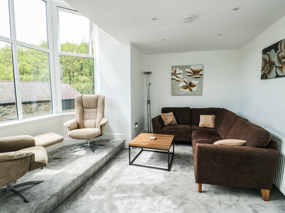A living room with a sofa and coffee table at River View in Betws-y-Coed