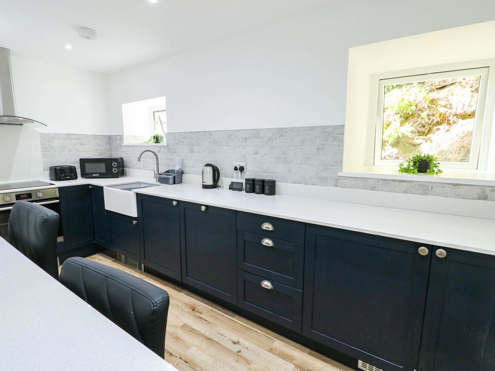A kitchen with cabinets and appliances at River View in Betws-y-Coed