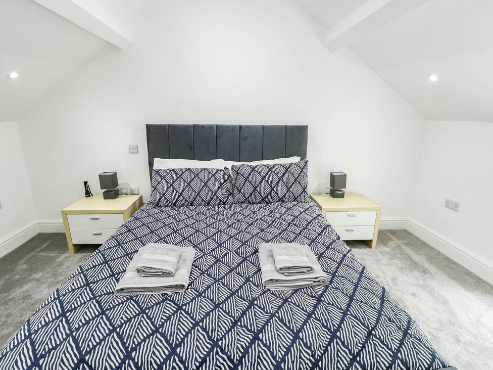 A bedroom with a bed and nightstands at River View in Betws-y-Coed
