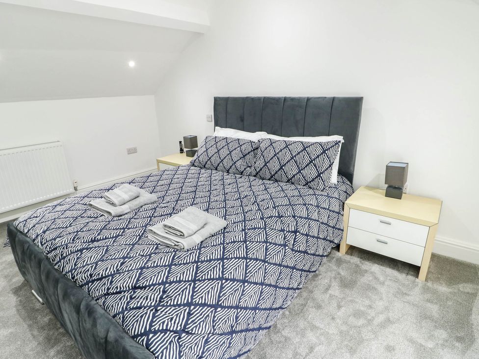 A bedroom with a bed and bedside table at River View in Betws-y-Coed