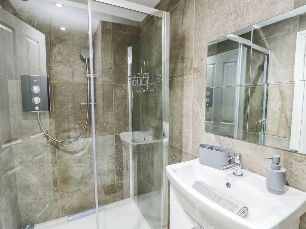 A bathroom with a shower and sink at River View in Betws-y-Coed
