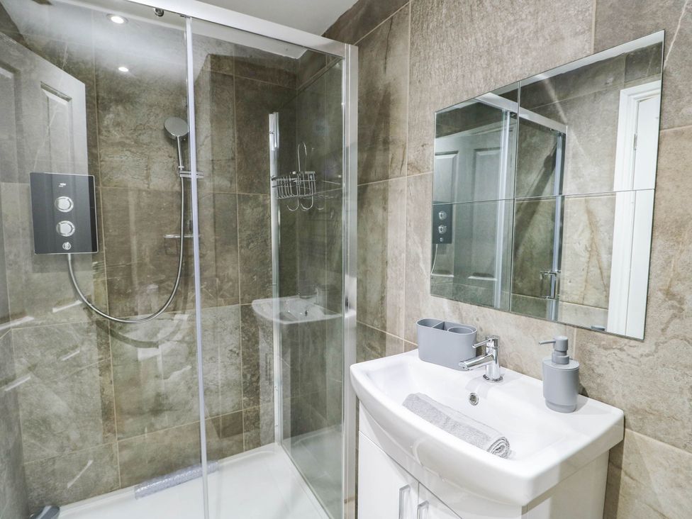 A bathroom with a shower and sink at River View in Betws-y-Coed